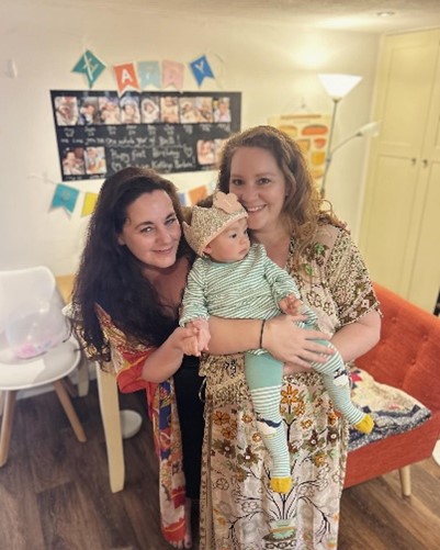 Jennifer and Maddie holding baby Beatrice.