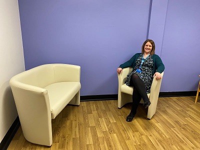 A woman sitting in a chair with her legs crossed.