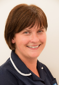 A person with brunette hair smiling in a navy blue uniform.