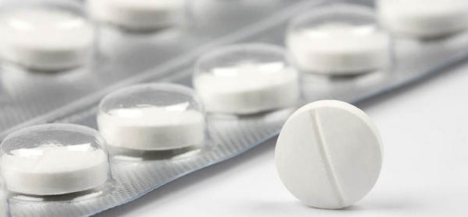 A close-up of a packet of white pills.